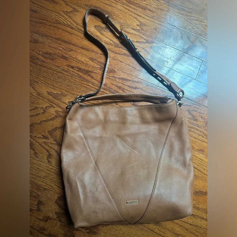 Rebecca Minkoff Moto hobo bag featuring prominent vertical zippers on the front.
